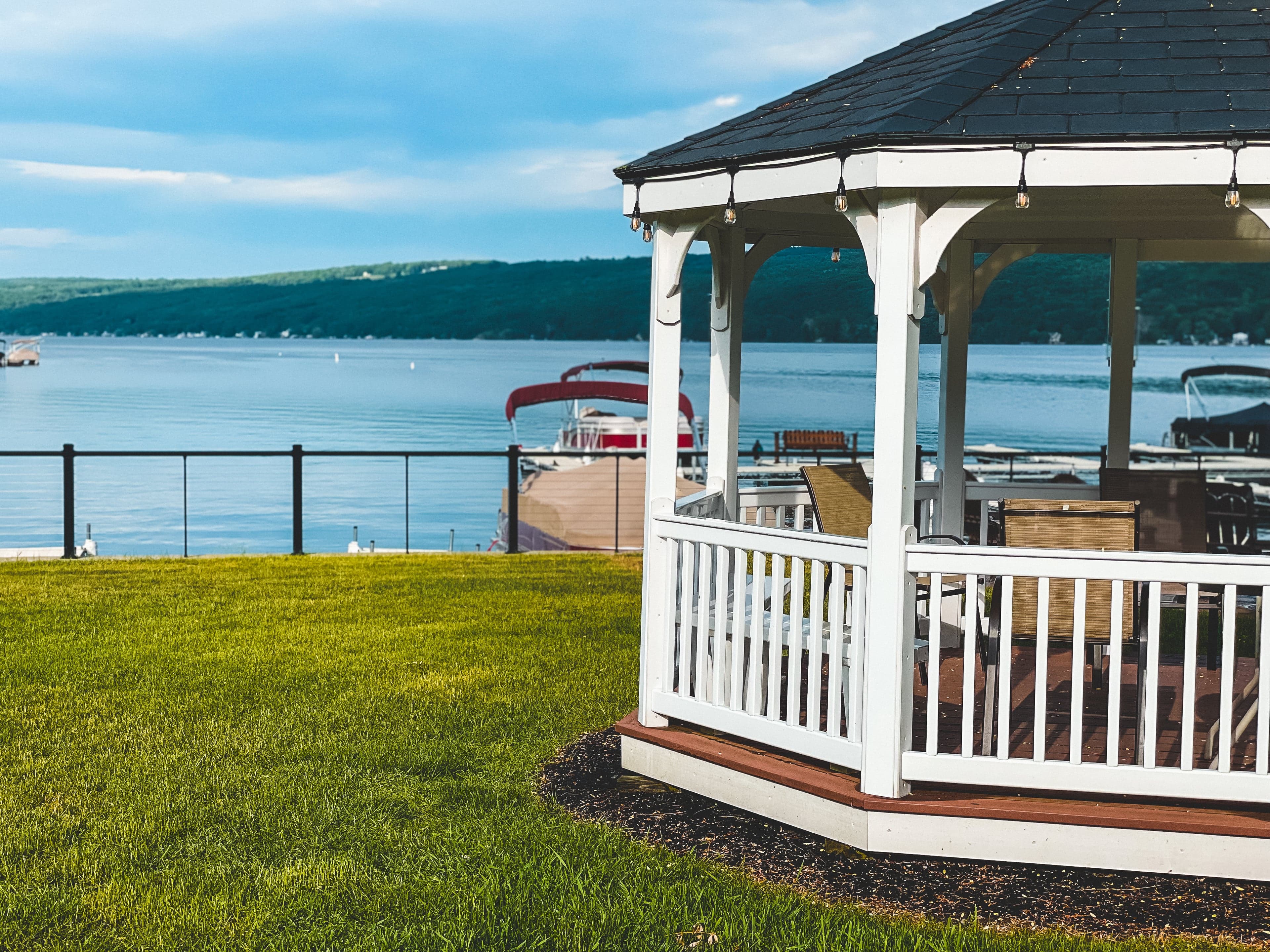 The white gazebo on the lawn at the water’s edge, looking out over Keuka Lake